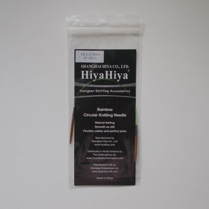May include: A package of HiyaHiya Bamboo Circular Knitting Needles in US size 2 (2.75 mm). The package is black with white text and features the HiyaHiya logo. The needles are made of bamboo and have flexible cables.