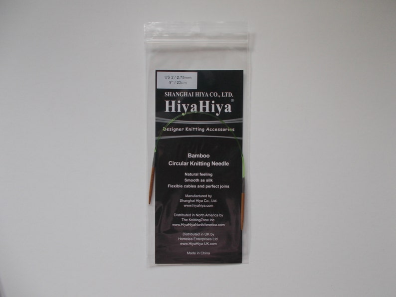 May include: A package of HiyaHiya Bamboo Circular Knitting Needles in US size 2 (2.75 mm). The package is black with white text and features the HiyaHiya logo. The needles are made of bamboo and have flexible cables.