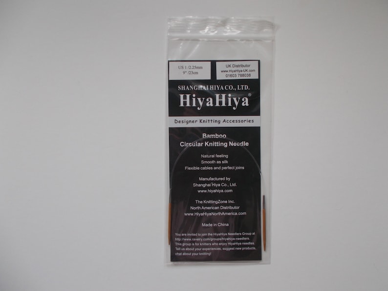 May include: A close-up of a package containing a pair of bamboo circular knitting needles. The package is labeled "HiyaHiya" and features the text "Bamboo Circular Knitting Needle".