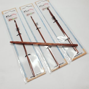May include: Three Knit Pro Ginger crochet hooks in individual packaging. The hooks are made of wood and are 3.00 mm, 3.50 mm, and 4.00 mm in size.