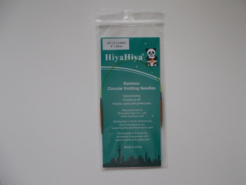 May include: A green and brown HiyaHiya Bamboo Circular Knitting Needle set in a clear plastic bag. The needles are 8 inches (23 cm) long and are size US 1.5/2.5mm.