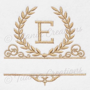 May include: Gold embroidered monogram with the letter E in a wreath design. The monogram is framed by a decorative border with a blank space below for a name.
