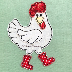 May include: A whimsical fabric applique of a chicken with a red comb and wattle, black eyes, and red polka-dot boots. The chicken is white with black outline stitching. The text "Titania Creations" is at the bottom.