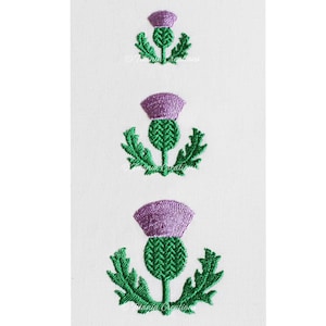 May include: Three embroidered purple and green thistle designs in different sizes. The thistles are a traditional Scottish symbol.