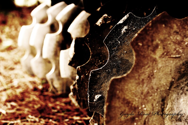 May include: Close-up of a rusty metal gear with a brown background. The gear has a unique, intricate design with sharp teeth.