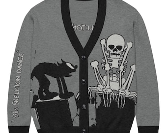 May include: A grey V-neck cardigan with black trim, featuring a black graphic of a cat on the left and a white skeleton on the right. The text "The Skeleton Dance" is printed on the left sleeve, and four black buttons run down the center front.