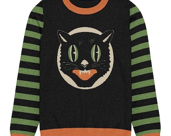 May include: A long-sleeve crewneck sweater featuring a black body with a central graphic of a black cat face with green eyes and an orange mouth. The sleeves have horizontal black and green stripes, and the collar and hem are solid orange.