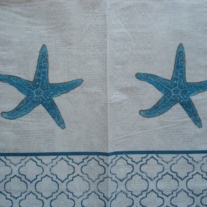 May include: Two blue starfish printed on a white background with a blue and white patterned border.