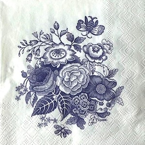 May include: A blue and white floral design on a white napkin with the word "Spode" in the bottom right corner.