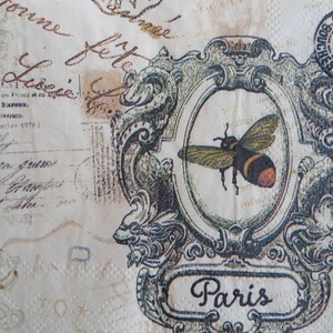 May include: A vintage-style image with a bee in a decorative frame. The frame has a scroll design and says "Paris" at the bottom. The image is on a cream-colored background with faded text.
