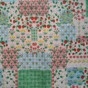 May include: A white fabric with a patchwork design featuring various floral patterns and red strawberries. The fabric has a vintage aesthetic and is perfect for crafting projects.