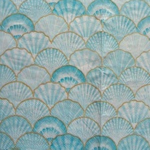 May include: A fabric with a repeating pattern of stylized seashells in shades of blue and white, outlined in gold. The design creates a textured, layered effect, suitable for coastal-themed decor or fashion.