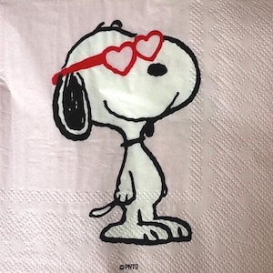 May include: A white Snoopy cartoon character wearing red heart-shaped sunglasses, set against a light pink background. The image is a close-up of the character, with black outlines and details. The background has a subtle, textured pattern.