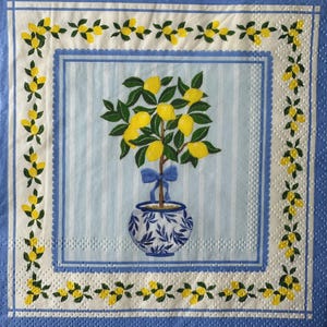 May include: Square paper napkin with a lemon tree design. The tree is in a blue and white patterned pot, with a blue bow. The background has vertical blue stripes. The border has a lemon and leaf pattern.