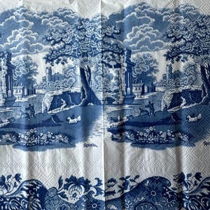 May include: Blue and white patterned paper napkins with a scenic design and the word "Spode" printed on each side.