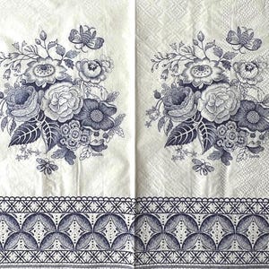 May include: Two white napkins with a blue floral design. Each napkin features a bouquet of roses, other flowers, and butterflies. The bottom border has a repeating geometric pattern. The word "Spode" is printed on each napkin.