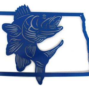 May include: A blue metal wall art piece featuring a leaping fish design within the outline of a state. The fish is detailed with etched lines, and the state outline has a clean, modern aesthetic. The artwork is suitable for home decor.