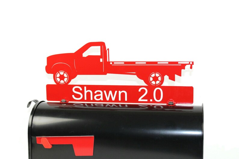 Pode incluir: Tope de caixa de correio de metal vermelho com uma silhueta de caminh&atilde;o de plataforma vermelha e o texto "Shawn 2.0".