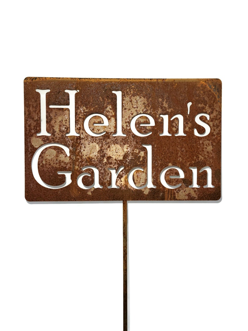 This is a custom garden stake sign. It has a face plate that is rectangle in size. It is attached to a steel rod.