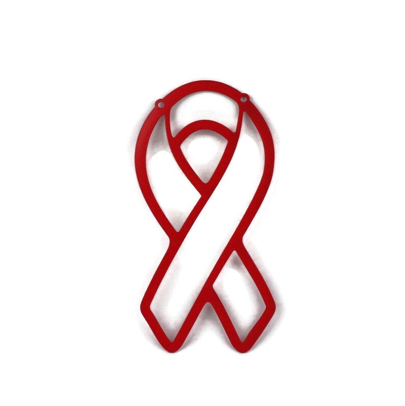 May include: A red awareness ribbon with a white center, symbolizing support for a cause. The ribbon is made of a solid material and has two small holes at the top. The design is simple and bold, set against a white background.
