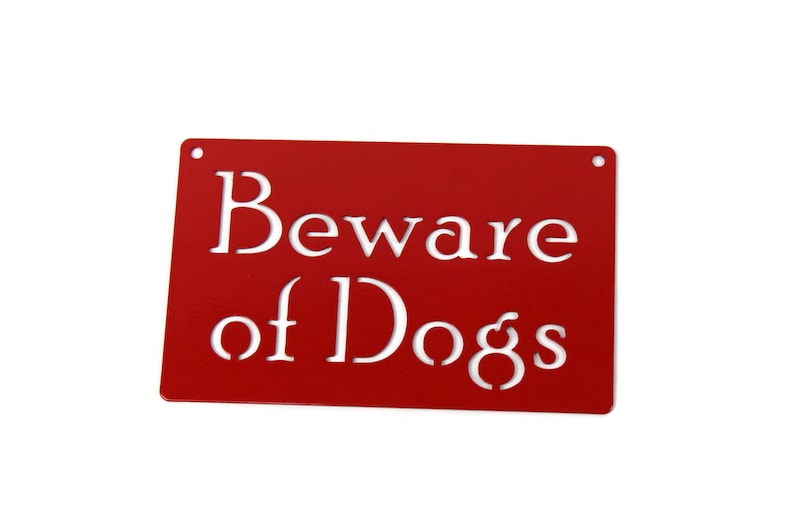 May include: Red metal sign with white lettering that reads "Beware of Dogs".