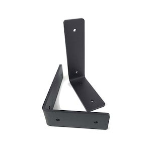 Heavy duty steel shelf brackets. Matte black in color. Two holes to support the bracket to the wall and two holes to connect to a shelf.
Sizes 4x5 inches or 5x7 inches.
