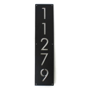 May include: Black metal house number plaque with the numbers 11279 cut out in a vertical line.