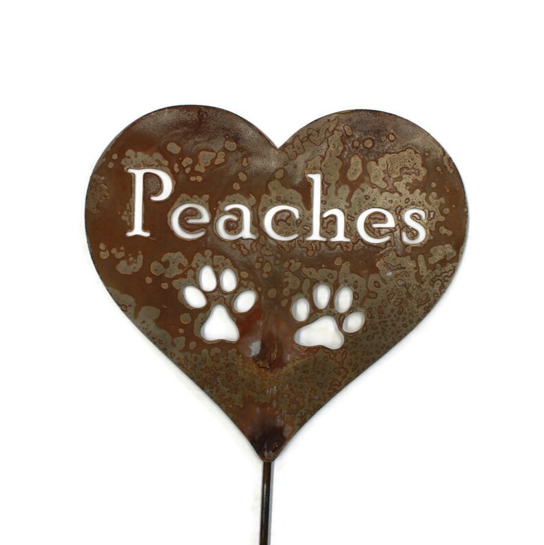 Peaches is the name with 2 paw prints below on the heart stake.