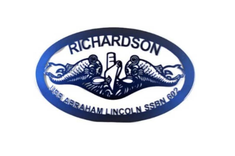 May include: A blue metal oval sign with the text "RICHARDSON" at the top, "USS ABRAHAM LINCOLN SSBN 602" at the bottom, and a submarine emblem in the center.