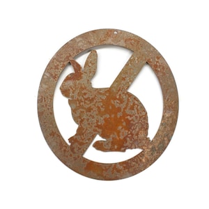 May include: A rusty metal sign with a circle and a diagonal line through it. Inside the circle is a silhouette of a rabbit. The sign is meant to indicate that rabbits are not allowed in the area.