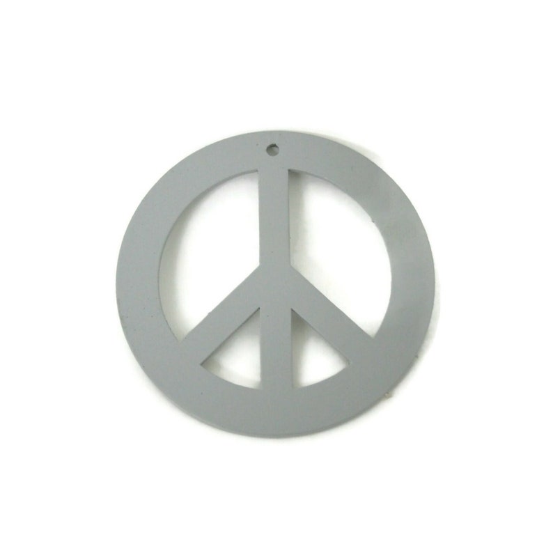 May include: A gray peace sign ornament with a hole at the top for hanging.