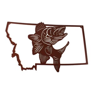 May include: A brown metal cutout of the state of Montana with a walleye fish jumping out of the state outline.