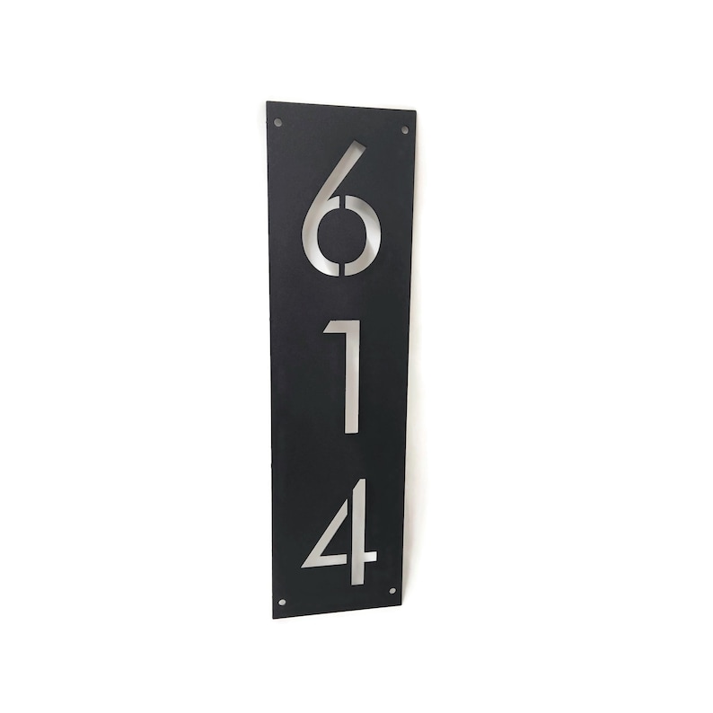 May include: Black metal house number plaque with the numbers 614 cut out in a silver finish.
