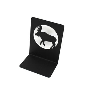 May include: Black metal bookend featuring a silhouette of a moose in a circle. The bookend is designed to hold books upright.