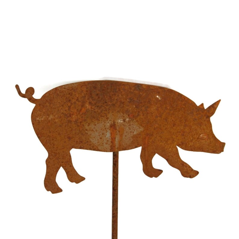 May include: A rusty metal pig silhouette garden stake. The pig is facing right and has a curled tail. The stake is brown and has a rustic look.
