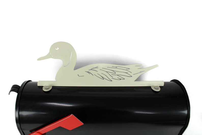May include: A black mailbox with a red flag and a white metal duck silhouette on top.