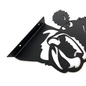 May include: Black metal shelf bracket with a bulldog silhouette. The bracket has two holes for mounting.