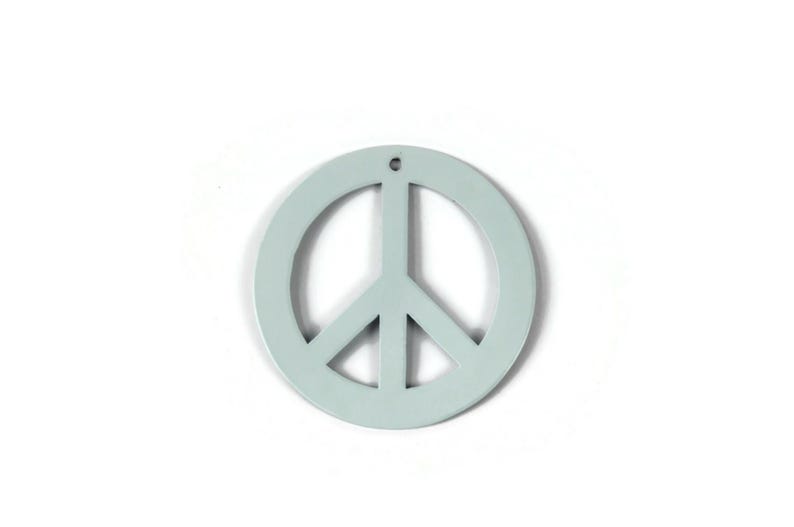 May include: A light blue peace sign ornament. The peace sign is a circle with a stylized dove inside.