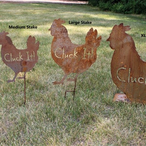 May include: Four metal chicken silhouettes with the text "Cluck It!" on each. The chickens are different sizes, with the largest one standing on a base and the smaller ones on stakes. The chickens are rusty brown in color.