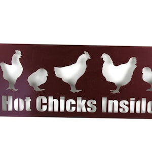 May include: A maroon metal sign with a white silhouette of five chickens and the text "Hot Chicks Inside".