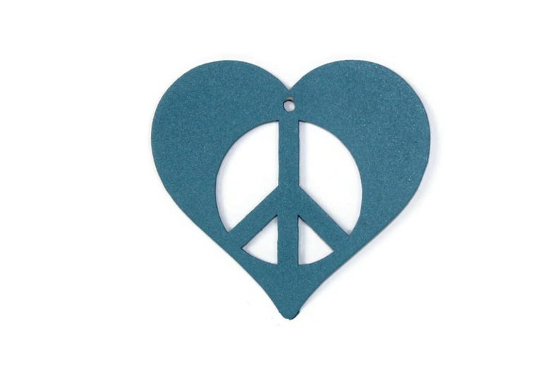 May include: A teal blue heart-shaped ornament with a peace sign cut out in the center.
