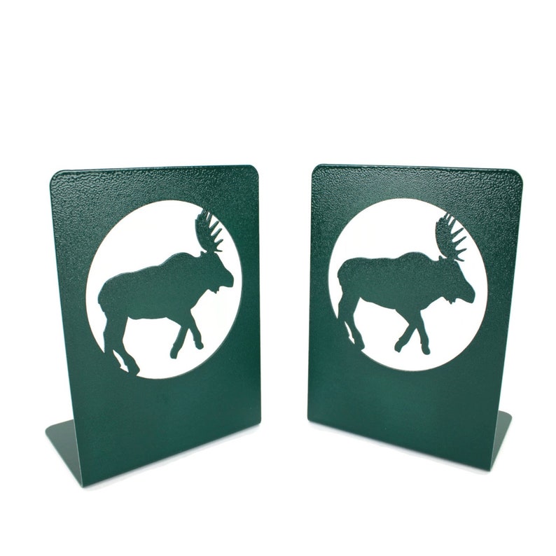 May include: A pair of green metal bookends with a moose silhouette cutout in each. The moose are in a white circle on a dark green background.