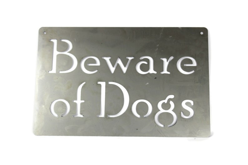 May include: A silver metal sign with the words "Beware of Dogs" cut out in white.