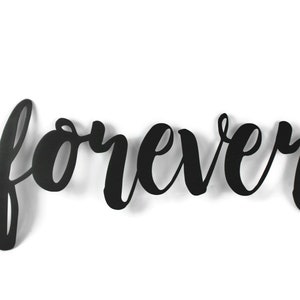 May include: Black metal wall decor with the word "forever" written in a cursive font.