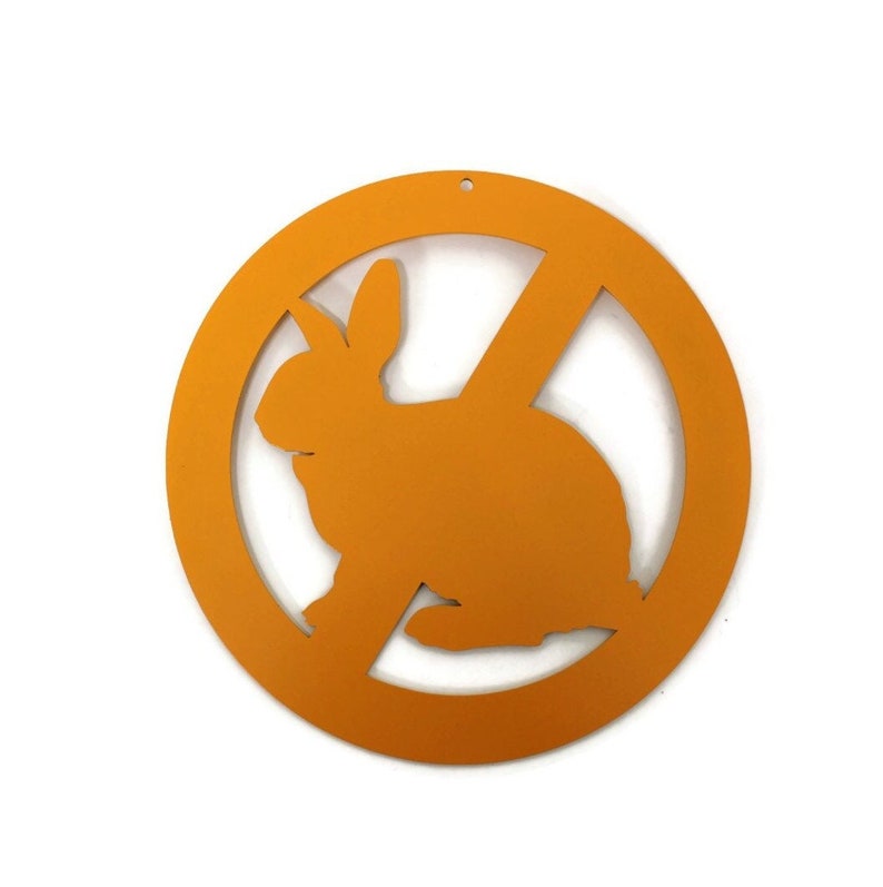 May include: Orange round sign with a diagonal line through the center. The sign has a silhouette of a rabbit inside.