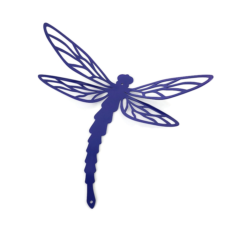 May include: A navy blue metal dragonfly wall art piece. The dragonfly has detailed cut-out wings and a segmented body. The design is a decorative accent for indoor or outdoor spaces. The dragonfly is a single piece and is shown against a white background.