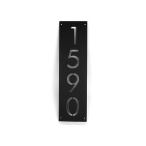 May include: Black metal house number plaque with the numbers 1590 cut out in a vertical line.