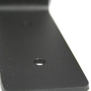 This picture shows one of holes in the bracket. Smooth edges and cuts. Powder coated matte black.