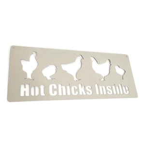 May include: A white metal sign with the text "Hot Chicks Inside" and cut-out silhouettes of chickens.