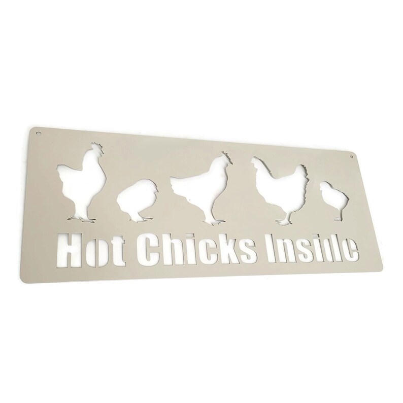 May include: A white metal sign with the text "Hot Chicks Inside" and cut-out silhouettes of chickens.
